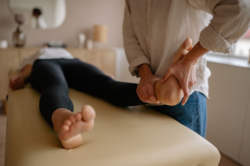 A woman receives physical therapy after suffering from joint mobility problems