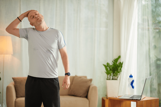 A man tries to stretch through his discomfort